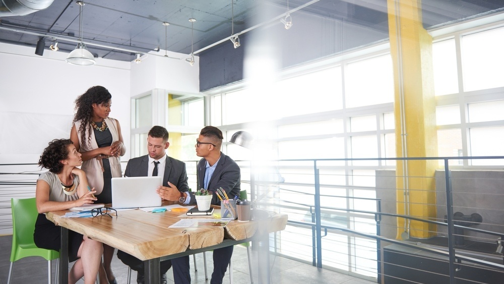 team of successful business people having a meeting in executive sunlit office-568659-edited