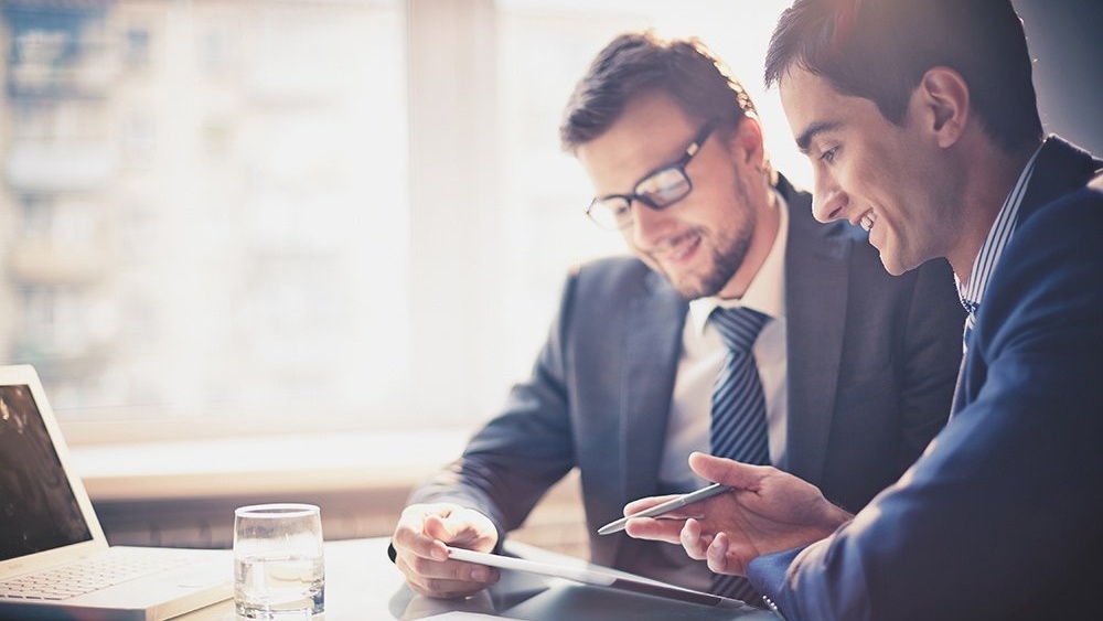 WEB - Two Businessmen Using a Tablet At a Meeting-159069-edited